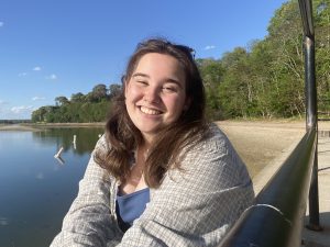 Amanda Rutha smiling in front of a lake